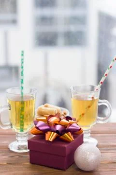 Two tea cups with straws,a gift box, a bowl of cookies and a christmas-tree Stock Photos