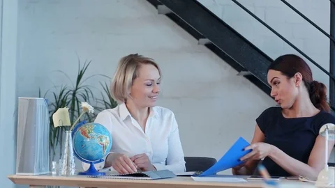 Two teachers of geography talking after classes 스톡 동영상 77419304