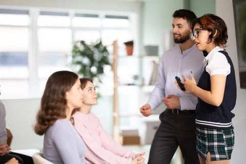 Two teachers speaking to Students in class Stock Photos