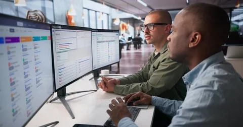 Two Team Members Analyzing Payroll Data On Computer For Employee Salary Autom Stock Photos