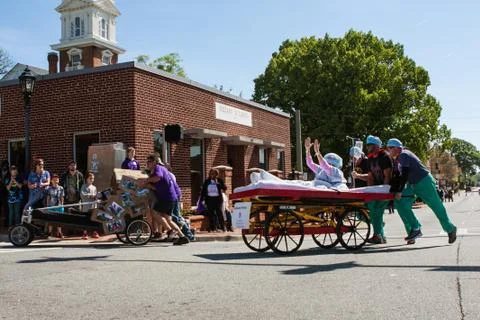 Two Teams Push Beds On Wheels In Charity Fundraiser Event Stock Photos