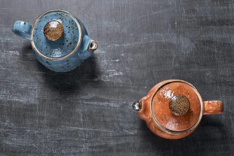 Two teapots on a dark background. Stock Photos