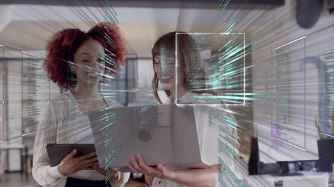 Two tech colleagues collaborating, focusing on laptop, sparking code overlay Stockbeeldmateriaal 335466133