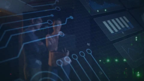 Two tech professionals interacting in control center, with holographic charts Stock Footage 309105833