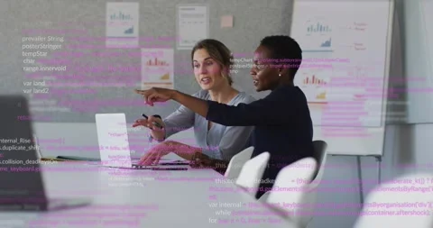 Two tech women working on laptop right pointing causing code overlay left typing Stock Footage 328366310