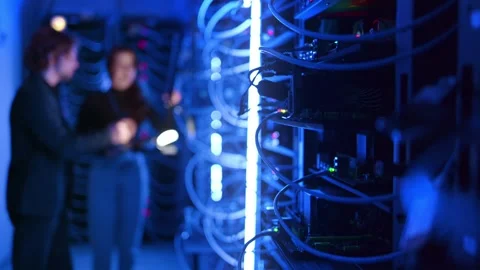 Two technicians discuss server room maintenance, focusing on data center in.. Stock Footage 339641088