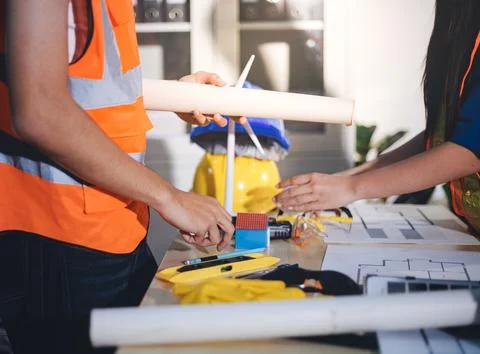 Two technicians inspect server racks in data center with tablet and fiber o.. Stock Photos