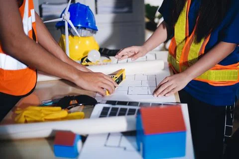 Two technicians inspect server racks in data center with tablet and fiber o.. Stock Photos