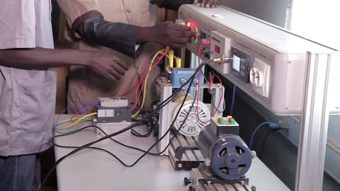 Two technicians manipulating an electronic device Stock Footage 200917083