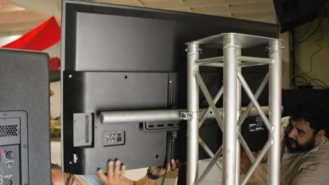 Two Technicians Mount Television on Event Truss Stock Footage 343358302