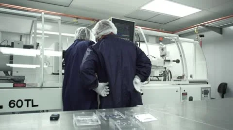 Two Technicians work together in Cleanroom Stock Footage 10895873