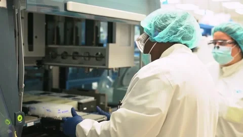Two technicians work together at a laboratory bench at a crime laboratory 스톡 동영상 345299223