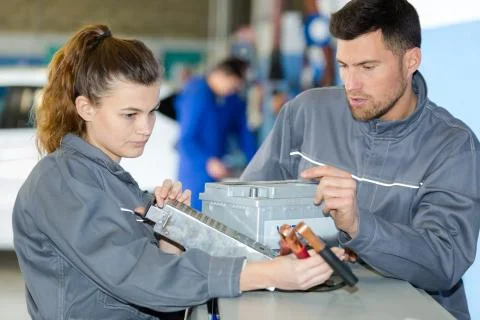 Two technicians work on a tool Stock Photos