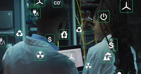 Two techs pointing at lit rack, viewing laptop and testing energy use with Stock Footage 331713185