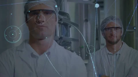 Two techs standing arms crossed in plant camera pulling in, HUD drifting across Video stock 331820800