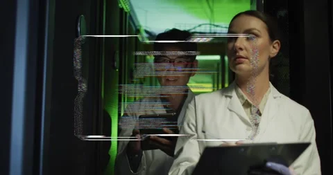 Two techs tapping tablet and writing notes, causing AR overlay showing Stock Footage 334312833