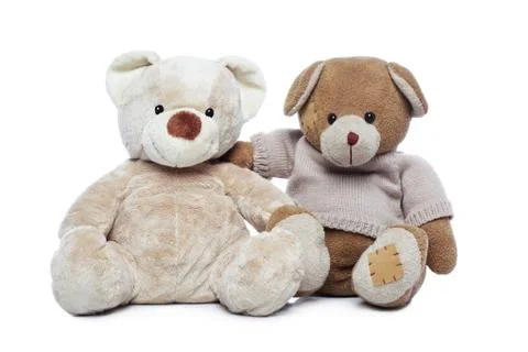 Two teddy bears hugging each other over white background Stock Photos