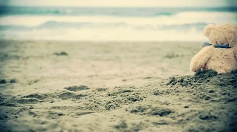 Two teddy bears sitting on the beach. Stock Footage 12010326