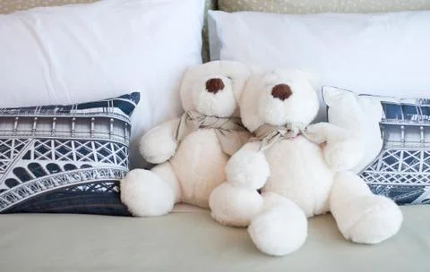 Two teddy bears sitting in the bed Stock Photos
