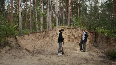 Two teenagers digging in pine forest 스톡 동영상 338168968