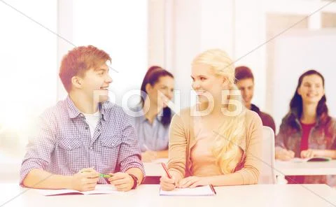 Two teenagers with notebooks at school Stock Photos