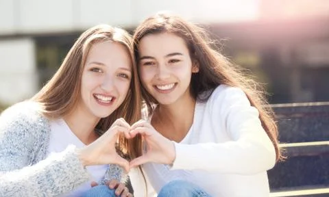 Two Teens Holding Hands in Shape of Heart Stock Photos