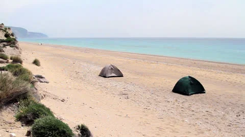 Two tents on a deserted beach Stock Footage 24735506