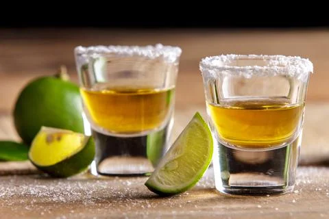 Two tequila shots with lime slice and salt Stock Photos