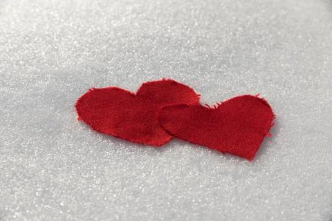Two textile heart on a snow Stock Photos
