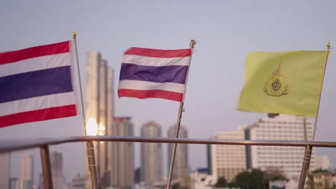 Two Thai flags fly on the railing of a ship next to the Maharaj Tanga and the Video stock 278335024