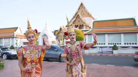 Two Thai Khon Dancers Perform Classical Dance Outside a Traditional Temple Stock Footage 337696195
