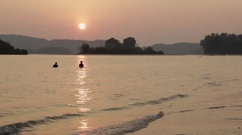 Two Thai men setting nets before low tide in Ao Nang, Thailand Stock Footage 51025672