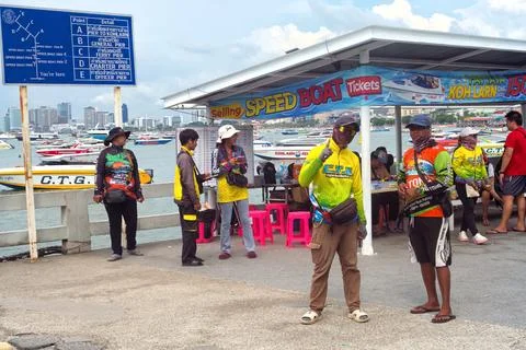 Two Thai men were posing in front of an outdoor shop for speed boat tickets Stock Photos