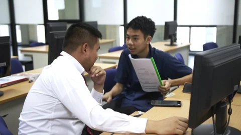 Two thai students discussing about their project Stock Footage 99139700