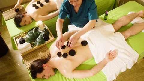 Two therapists doing chinese stone therapy Video stock 89684875