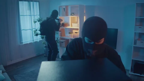A Two Thieves in Black Clothes and a Mask Broke Into an Apartment or House. Stock Footage 239882878