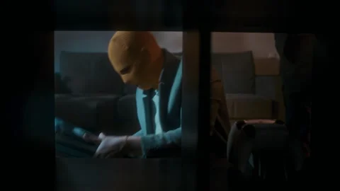 Two thieves with their faces covered steal household items from a house Stock Footage 312985675