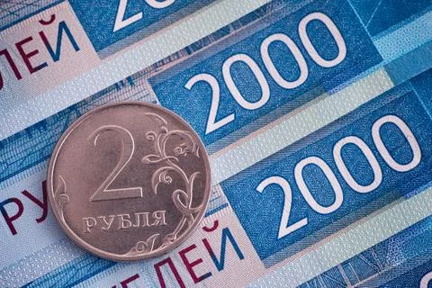Two thousand ruble banknotes and two-ruble coin. Stock Photos
