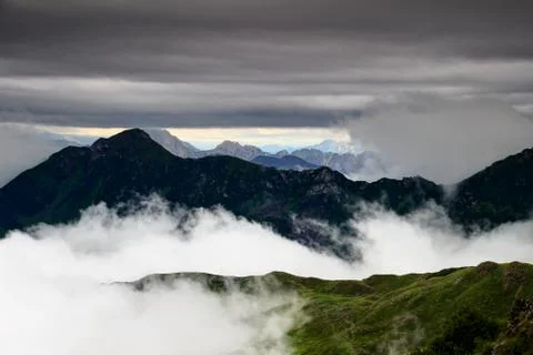 Two-thousander peaks of Carnic Alps in the clouds in Italy Stock Photos