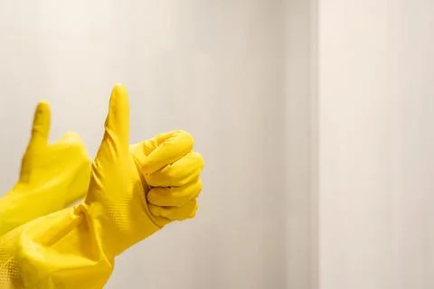 Two thumbs up gesture with yellow rubber gloves on hands Stock Photos