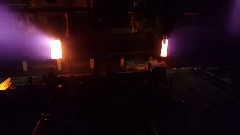 Two tick-borne cranes lower bright metal ingots into an ingot truck Video stock 123010056