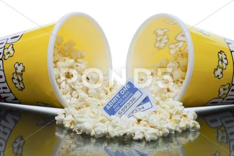Two tickets and spilled popcorn Stock Photos