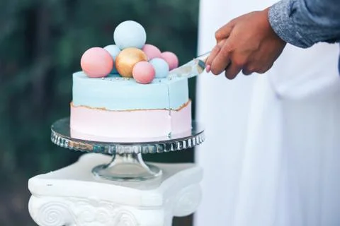 Two-tier cake is two-tone, the bottom of the cake is pink and the top is blue Stock Photos