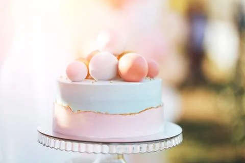 Two-tier cake is two-tone, the bottom of the cake is pink and the top is blue Stock Photos