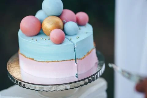 Two-tier cake is two-tone, the bottom of the cake is pink and the top is blue Stock Photos