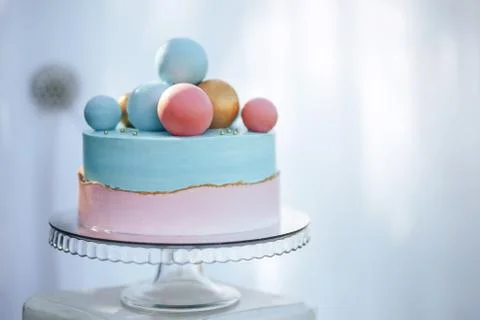 Two-tier cake is two-tone, the bottom of the cake is pink and the top is blue Stock Photos