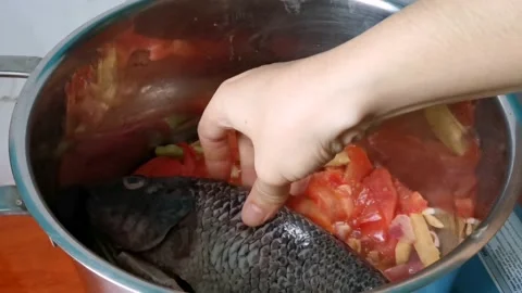 Two Tilapia Fish inside a Casserole Stock Footage 159319947