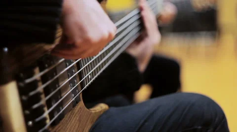 Two at a Time Playing the Guitar and Bass Guitar. Close-Up of Strings Stock Footage 62054778
