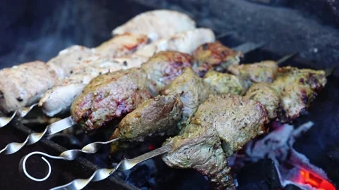 Two tipes of marinated shashlik preparing on barbecue grill over charcoal Stock Footage 212210388