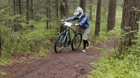 Two tired men go to the hill with mountain bike at Cross Country championship Stock Footage 53000759